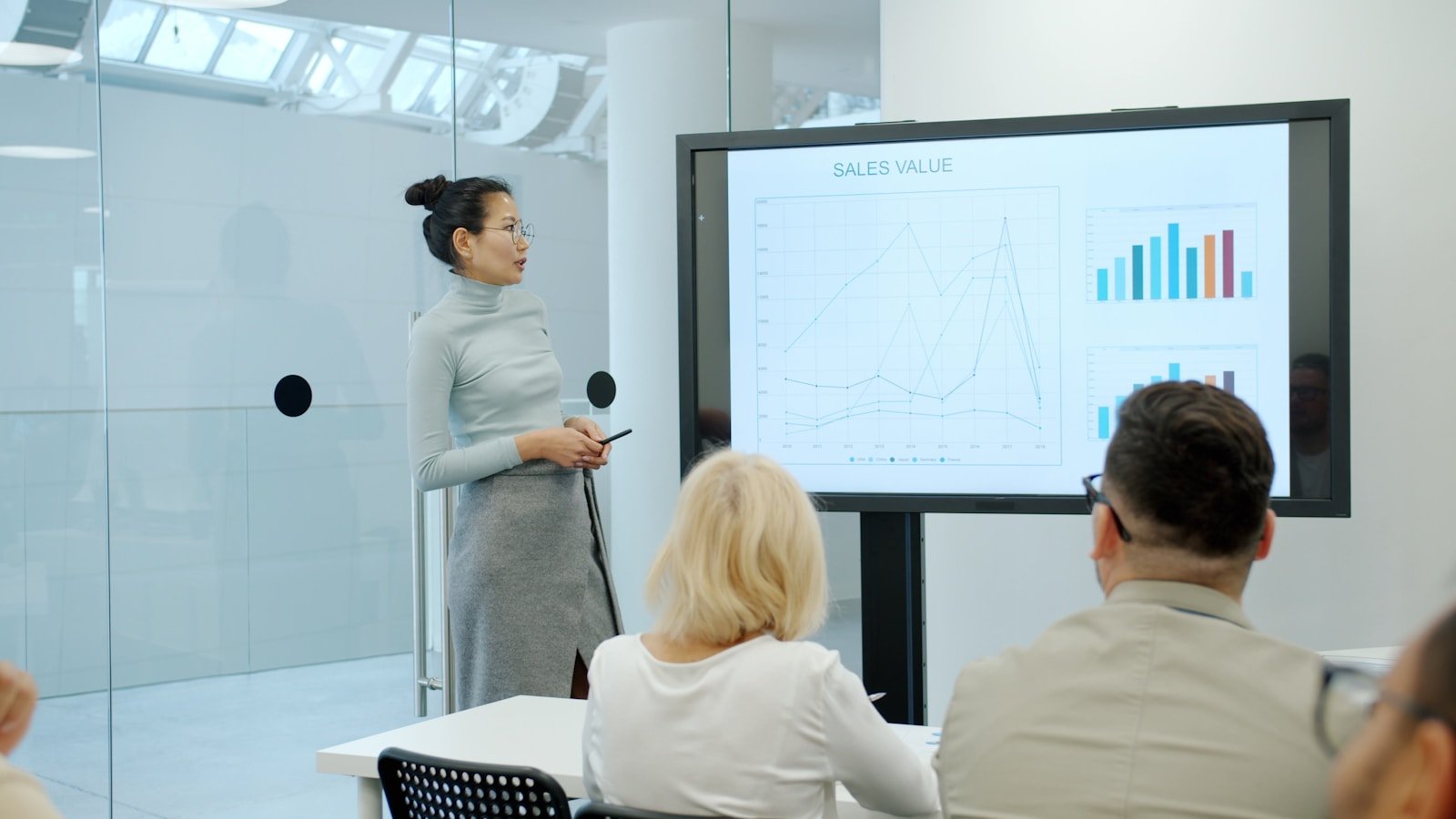 Woman presenting a graph to an audience
