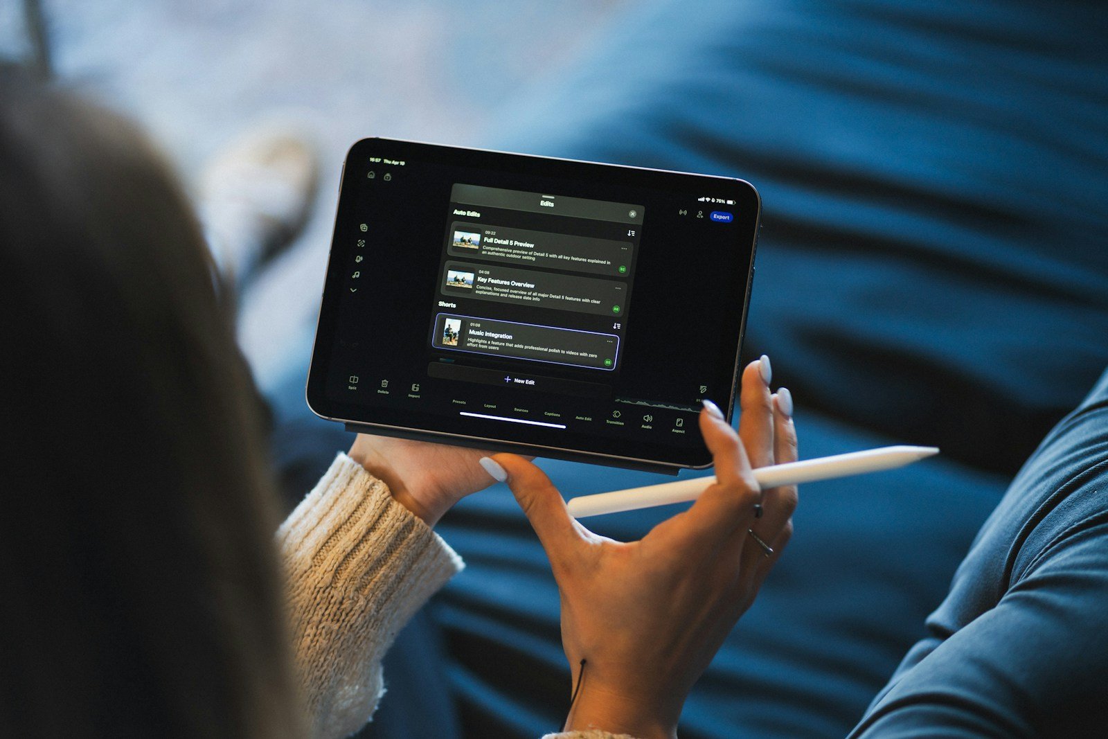 Person holding a tablet and stylus device.